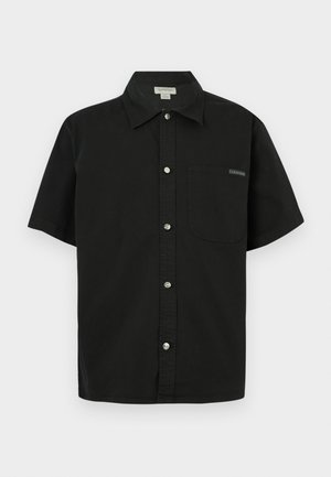 Black short-sleeve shirt made of cotton, featuring a button-up front, single chest pocket, and small logo accent near the pocket.