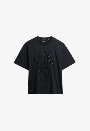 Zwarte katoenen t-shirt met een verhoogd zwart pailletten slangontwerp op de voorkant, korte mouwen en een ronde halslijn met een logo label.