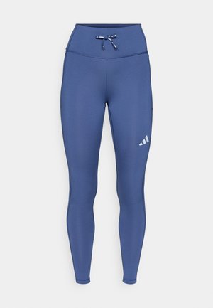 Marineblå treningsleggings med høy midje, justerbar snøring og et hvitt logodetalj på venstre lår. Glatt tekstur.