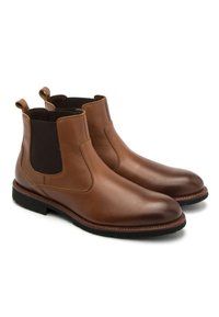 Brązowe skórzane buty typu Chelsea z elastycznymi panelami bocznymi, uchwytami do zakupu i gładkim, błyszczącym wykończeniem. Wytrzymałe gumowe podeszwy zapewniają przyczepność.