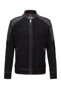 Svart mocka- och läderjacka med ståkrage, två fickor med dragkedja fram och kontrasterande läderaxeldetaljer. Slät textur.