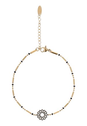 Delikat guldkædearmbånd med små sorte perler og et centralt sort blomsterformet vedhæng, udstyret med en justerbar lukning og forlængerkæde.