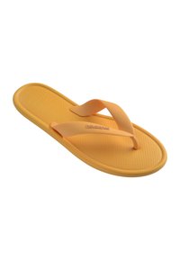 Tongs en caoutchouc orange unique avec semelle texturée et brides en forme de Y placées sur un fond blanc.