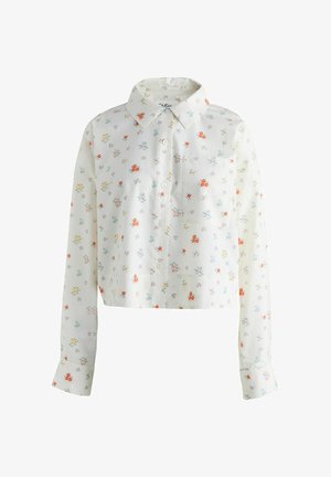 Biele dlhé rukávy skrátená košeľa s golierom, prednými gombíkmi, náprsným vreckom a malým farebným kvetinovým vzorom.