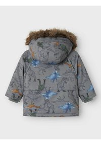 Grå jakke med dinosaur-print i flere farver. Har en fuskepelsforet hætte og en afslappet pasform med lange ærmer.