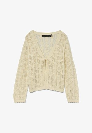 Cardigan lavorato a maglia di colore crema con un motivo geometrico a giorno, caratterizzato da un collo a V e una chiusura a lacci nella parte anteriore. Dettaglio con orlo scallop.