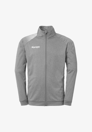 Gray zip-up jacket with a textured pattern on the shoulder, features the brand "Kempa" in white on the chest. Soft fabric and flexible fit.
