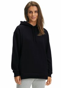 Felpa nera con cappuccio e coulisse, caratterizzata da una vestibilità ampia e maniche con polsini a coste. Realizzata in un tessuto morbido, offre una texture confortevole.