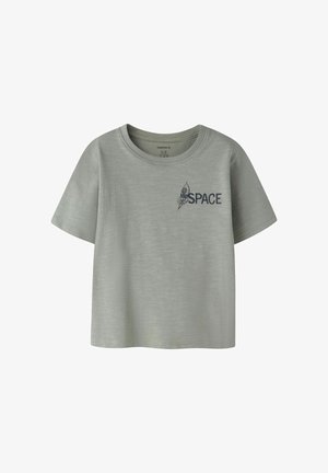 Camiseta de manga corta de color gris claro con un pequeño gráfico de un cohete y la palabra "ESPACIO" en el área izquierda del pecho.