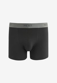 Fekete boxer alsónadrág puha anyagból, szürke elasztikus derékpánttal, amelyen sötét betűkkel a "NEXT" felirat olvasható.