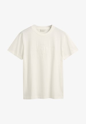Valkoinen puuvillainen T-paita, jossa on lyhyet hihat, pyöreä kaula-aukko ja kohokuvioitu "GANT 1949 AMERICAN SPORTWEAR" -logo rinnan kohdalla. Pehmeä rakenne.