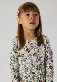 Long-sleeve dress with a floral pattern in multiple colors on a light background. Soft fabric with a round neckline and gathered waist detailing.