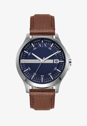 Armani Exchange wristwatch with blue textured dial, silver markers, date display at 3 o'clock, and brown leather strap, showing 10:10:36 time.