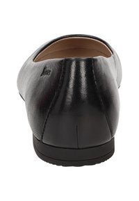 Black leather flat shoe with a rounded toe, smooth texture, minimal back seam detail, and a flexible black rubber sole.