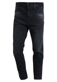 Tmavě modré džíny z denimu se slim fit, pěti kapsami a minimálními detaily šití. Obsahují zapínání na knoflík a poutka na opasek.