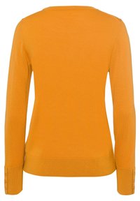 Pull orange à manches longues avec une texture côtelée, un col arrondi et des boutons en décoration aux poignets. Tissu en maille lisse.