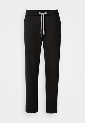 Pantalones de chándal negros, confeccionados en una tela suave, con una cinturilla elástica y cordón ajustable, además de bolsillos laterales. Diseño casual con un corte recto.