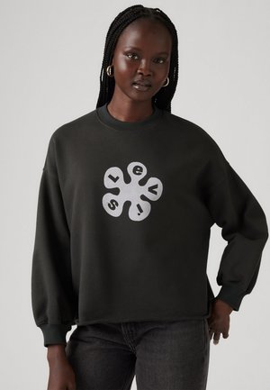 Mørkegrønn sweatshirts med lange ermer, rund hals og et stort hvitt grafisk logo i midten. Holdbart bomullsmateriale og avslappet passform.