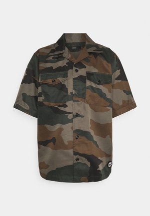 Chemise à manches courtes avec motif camouflage vert, marron et noir, dotée de deux poches poitrine à boutons.