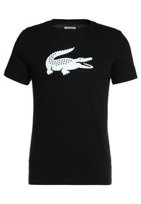 T-shirt nera in cotone con maniche corte, caratterizzata da un grande logo bianco di coccodrillo centrato sulla parte anteriore. Design semplice ed elegante.