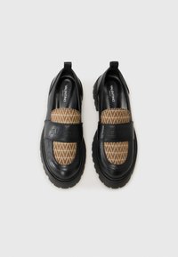 Black leather loafers featuring a brown fabric panel with a geometric pattern, rubber soles, and an embossed strap with the brand name.