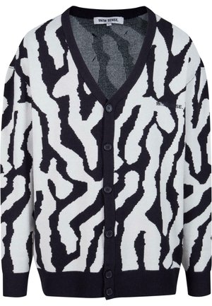 Black and white patterned cardigan with a V-neck, button closure, ribbed cuffs, and hem. Made from a soft knit material.