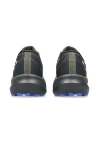 Black athletic shoes with a textured upper, green accents, and a thick sole featuring blue and yellow tread patterns.