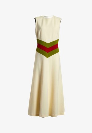 Robe crème sans manches avec une jupe évasée et des rayures en chevrons vertes et rouges à la taille.
