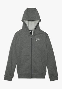 Grå zip-up hoodie med en mjuk insida, justerbar huva, två framfickor och en vit Nike-logotyp på vänster bröst. Material i bomullsblandning.