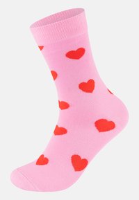 Ružová členková ponožka s červenými srdiečkovými vzormi, rebrovaným manžetovým lemom a mäkkou, elastickou tkaninou. Má vystuženú pätu a prsty pre väčšiu odolnosť.