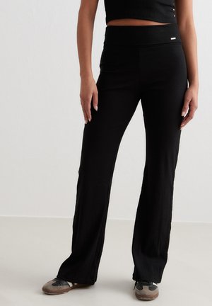 aim’n®, EASE RIBBED - Trousers - black