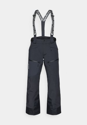 Juodos slidinėjimo kelnės su reguliuojamomis petnešomis, užtrauktukais užsegamomis kišenėmis ir tekstūruotais intarpais. Savybės: sustiprinti sijonai ilgaamžiškumui.