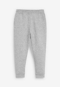 Pantalons de survêtement gris clair en tissu doux, dotés d'une taille élastique, de jambes fuselées et de poignets ajustés aux chevilles.