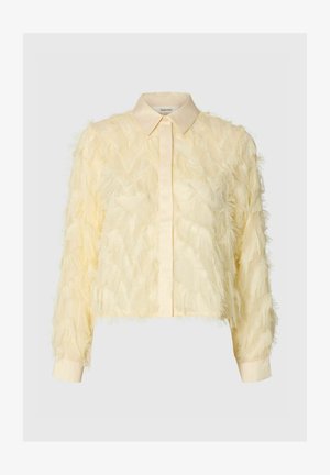 Chemise jaune à manches longues avec un design de frange texturée, dotée d'un col pointu, fabriquée en tissu léger.