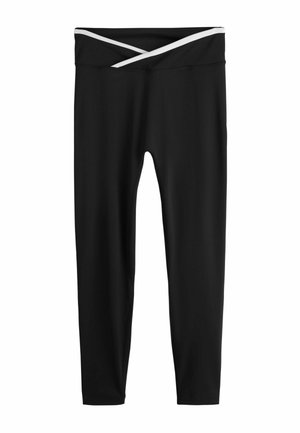 Schwarze Leggings aus weichem, elastischem Stoff mit einem weißen, überkreuzten Band am Bund. Glatte Textur und figurbetontes Design.