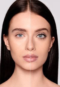 Metà del viso mostra un tono di pelle naturale e ciglia nude; l'altra metà presenta ciglia definite e labbra leggermente lucide. Texture della pelle liscia.