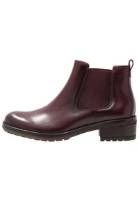 Burgundy nahka nilkkuri, jossa on joustavat sivupaneelit, pyöristetty kärki ja matala pinottu korko; kuvioitu kumipohja pitävyyttä varten.