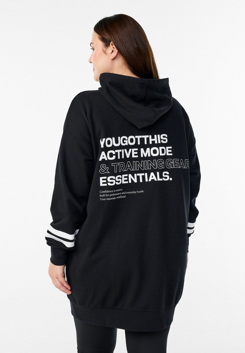 Melns sporta krekls ar vaļēju piegriezumu, uz muguras baltu uzrakstu un baltām svītrām uz piedurknēm. Mīksts, ikdienišķs audums. Ar kapuci.