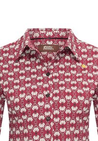 Red floral shirt featuring a pattern of white flowers with black accents, button-down front, and a collar. Textured fabric with a smooth finish.