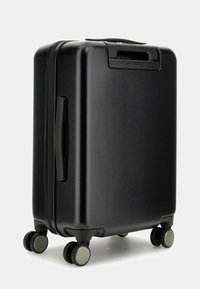 Black hard-shell suitcase with a smooth finish, dual wheels, a top handle, and a zipper closure. Compact rectangular design for travel.
