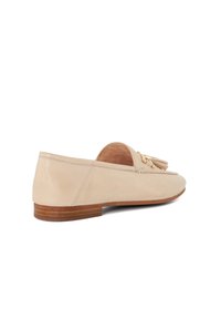 Beige leren loafers met een lage hak, voorzien van een franjedetail aan de voorkant en minimale stiksels. Glad oppervlak en een afgeronde neusontwerp.