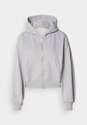 Lühendatud hall kapuutsiga jakki pehmest kangast, millel on tõmblukk, suur kapuuts ja kaks eesmist taskut elastsete varrukatega.