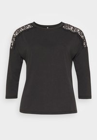 T-shirt nero a maniche lunghe con collezione a girocollo, caratterizzato da dettagli in pizzo sulle spalle. Tessuto morbido e liscio con una vestibilità rilassata.