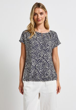 Marineblaues und cremefarbenes gemustertes Blusenshirt mit kurzen Ärmeln, entspanntem Schnitt und rundem Ausschnitt. Strukturierter, leichter Stoff.