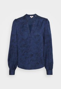 Blusa blu navy con maniche lunghe e voluminose, scollo a V e motivo floreale testurizzato. Tessuto morbido con leggera lucentezza, polsini arricciati.