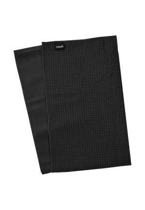 Black fitness towel made of textured fabric with a patterned surface. Features a sewn edge and a small brand tag. Rectangular shape.