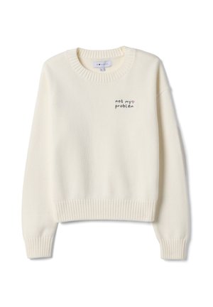 Sudadera color crema con puños y dobladillo acanalados. Presenta texto bordado "not my problem" en negro y rosa, diseño de cuello redondo.