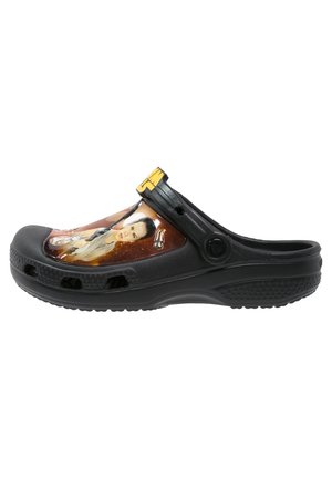 Černé nazouvací dřeváky s grafikou postavy ze Star Wars a žlutým „T“ na nastavitelném pásku na patě.