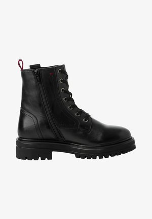 Bottes de cheville en cuir noir avec une fermeture éclair sur le côté, bout rond, semelle en caoutchouc et tirer contrastant à l'arrière. Design à lacets avec œillets en métal.
