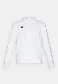 Veste de sport blanche à fermeture éclair, manches longues, col montant et logo adidas noir sur la poitrine gauche. Tissu lisse et léger.